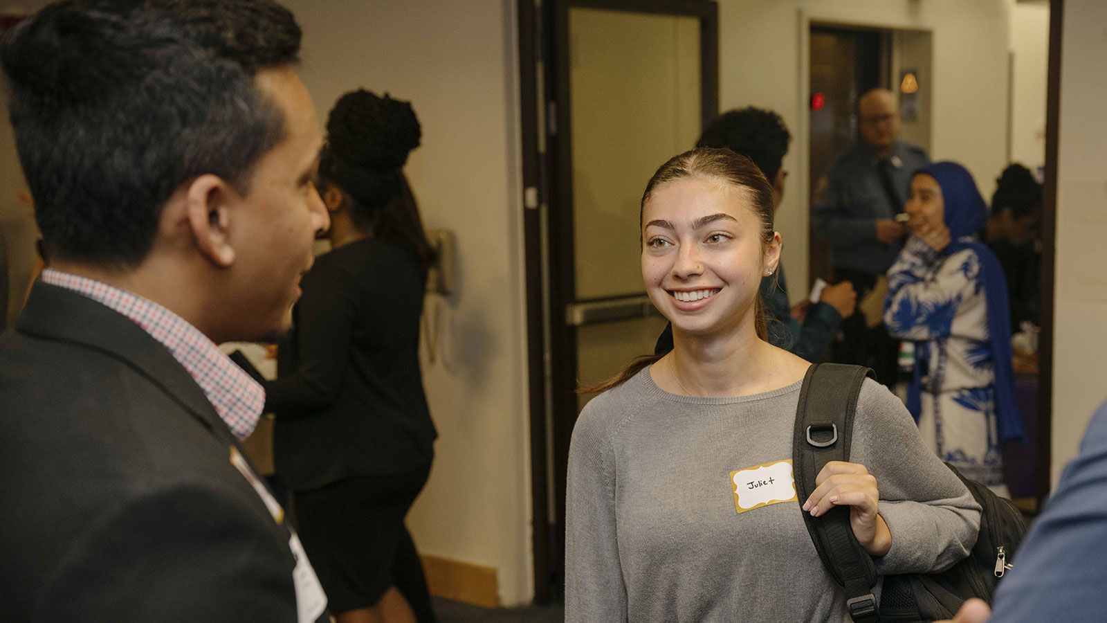 Hunter business student smiling with group of peers at Gala