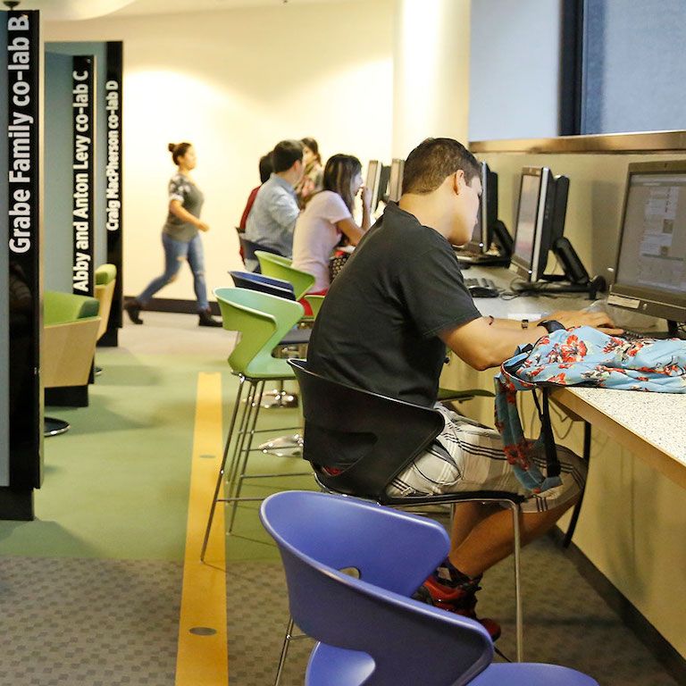 student on computer in hunter library