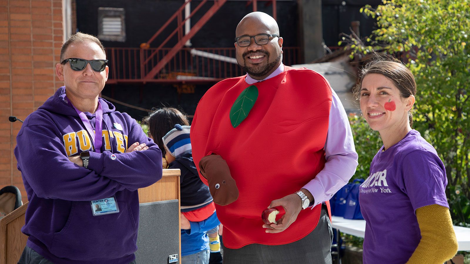 3 people holding apples for big apple crunch