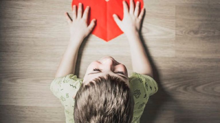 boy holding paper heart