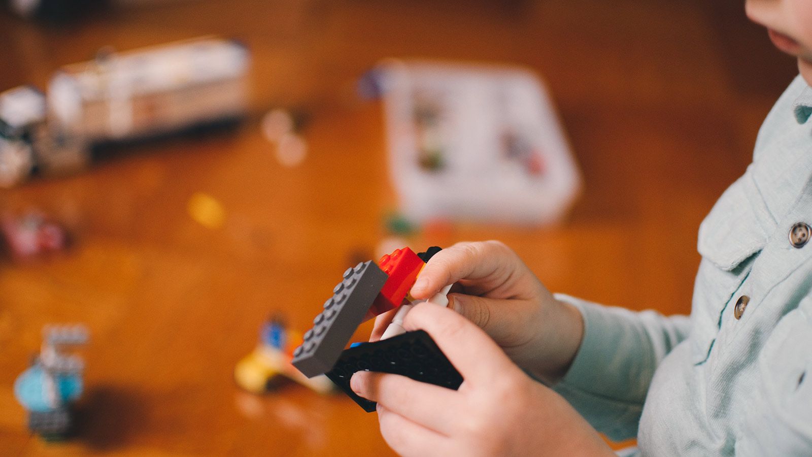 boy holding legos