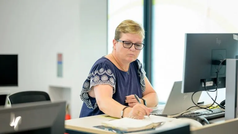 Woman at computer writing