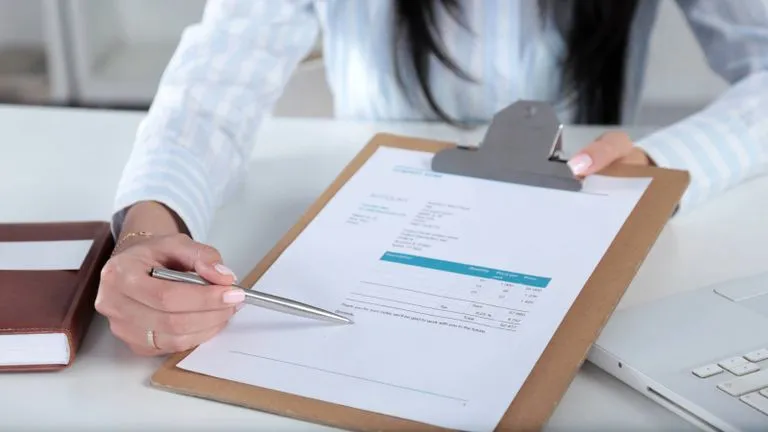 Somebody pointing at something on paperwork