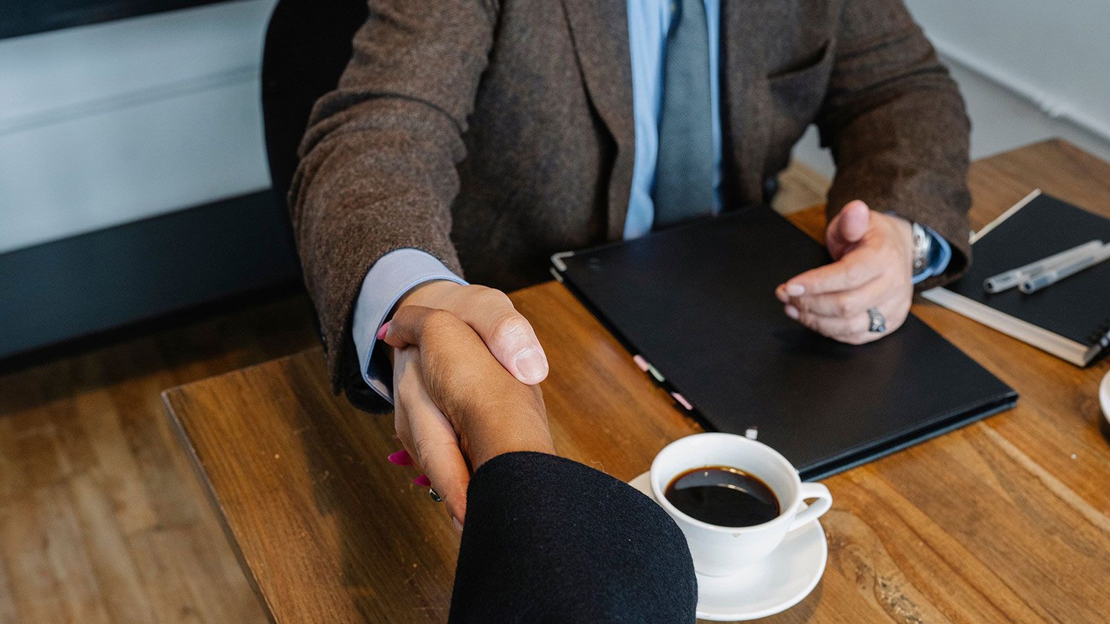 professionals shaking hands over coffee break