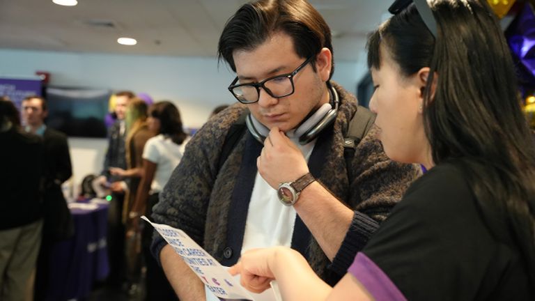 Student looking at job flyer
