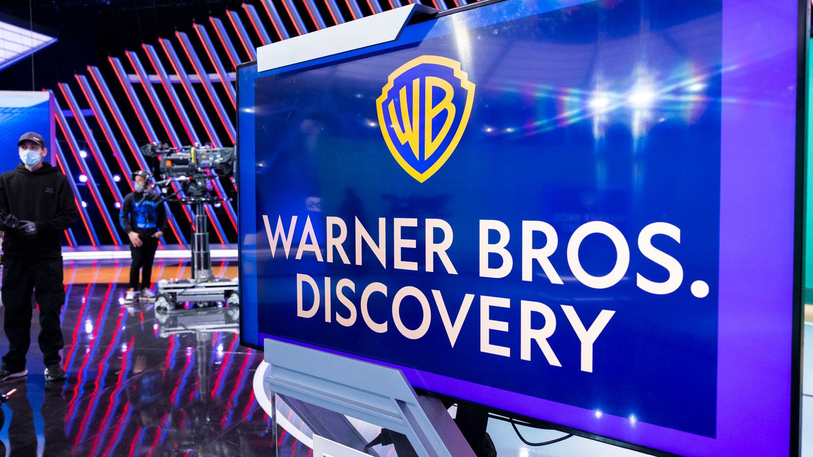 Photo - Warner Bros Discovery logo on set with staff and camera on a dolly.