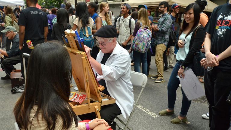 student painting at an easel