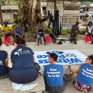 Community organizers sitting in a circle in Colombia