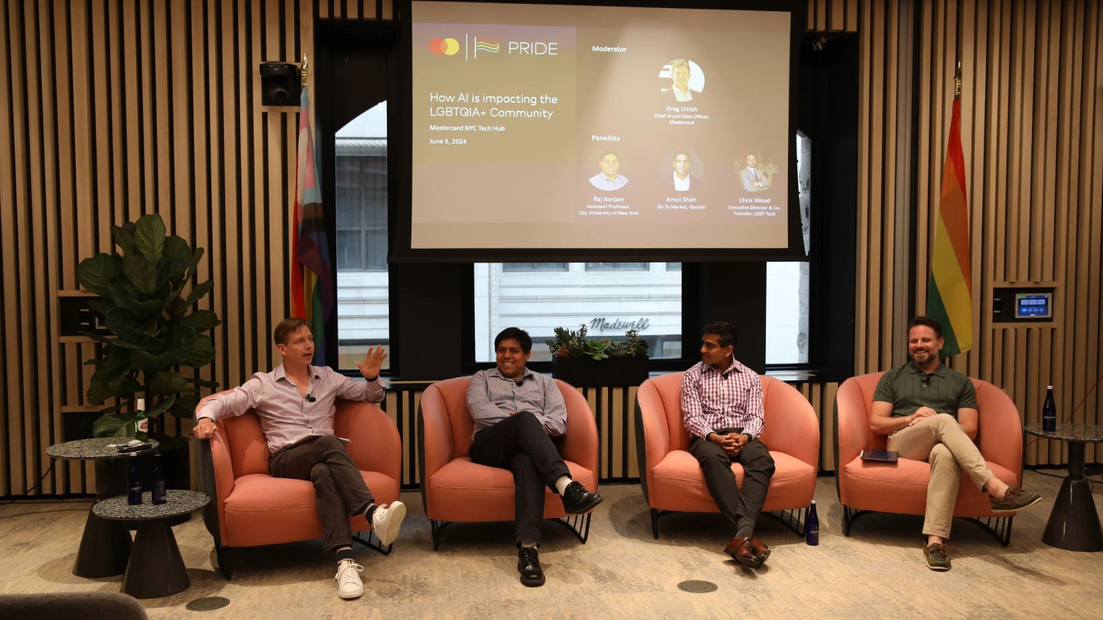 Four people sitting in chair at a panel