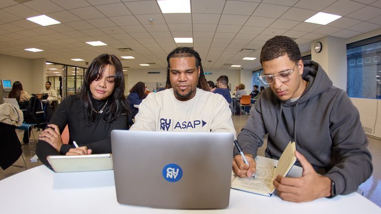 asap students sitting at classroom desk on laptop and taking notes