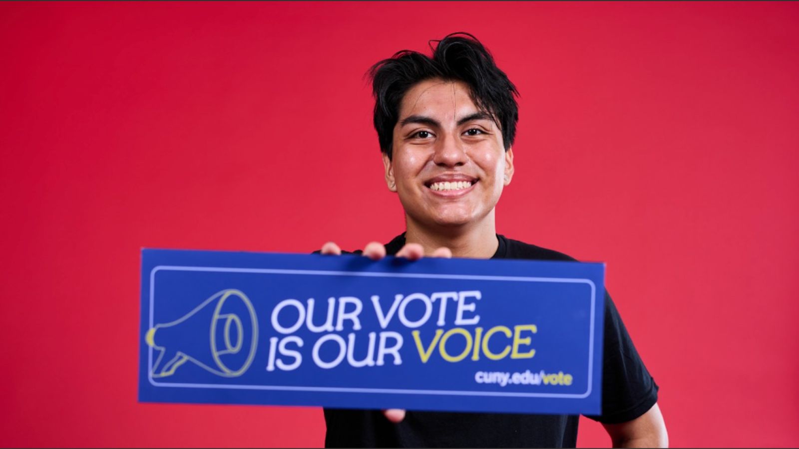 A person holds a sign saying “Our vote is our voice.”