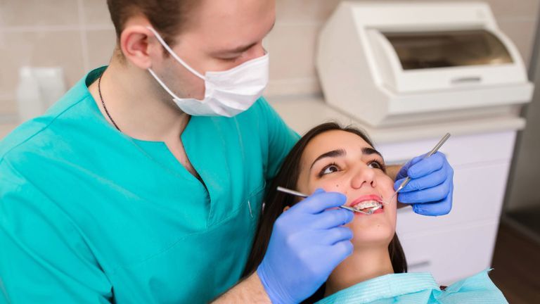 Dentist examining patient's teeth