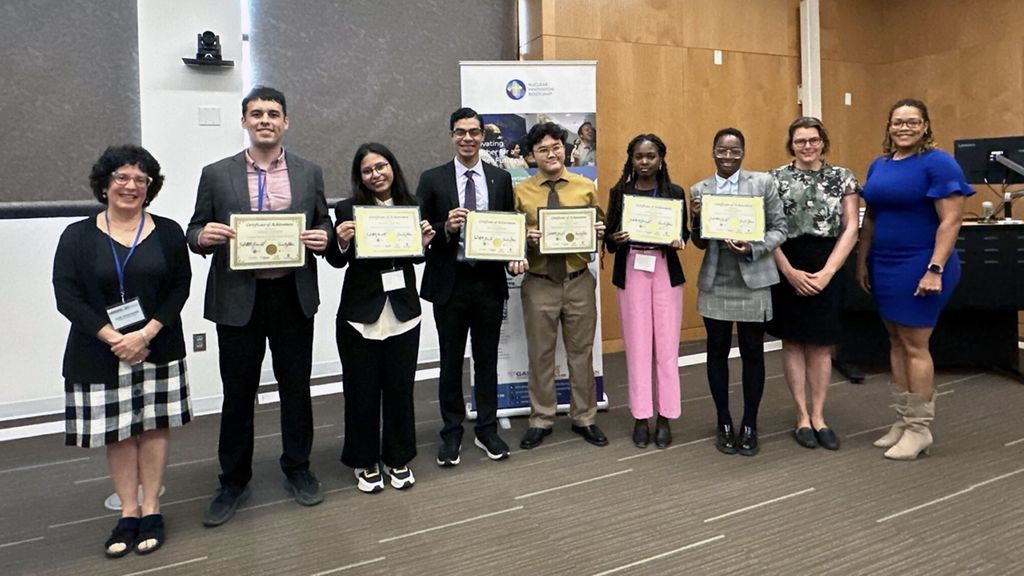 Howell (in pink pants) and her team display their certificates.