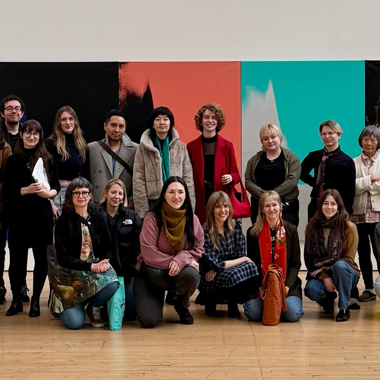 Students pose in front of artwork at DIA