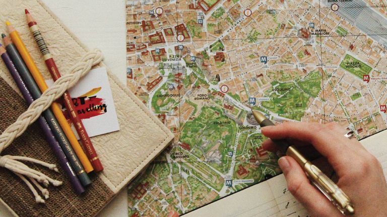 photo of someone planning a trip on a map