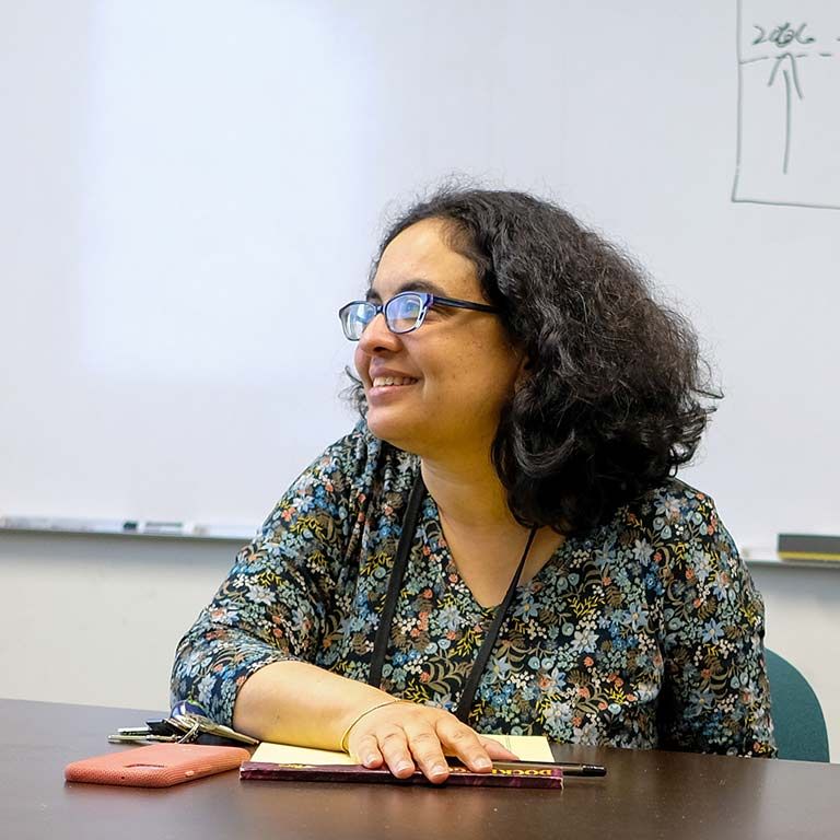 Econ faculty sitting at a desk