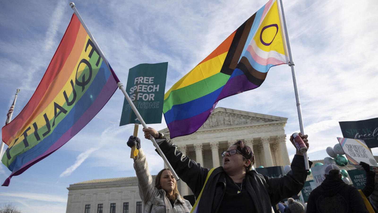 Photo of person waving equality flags in Washington