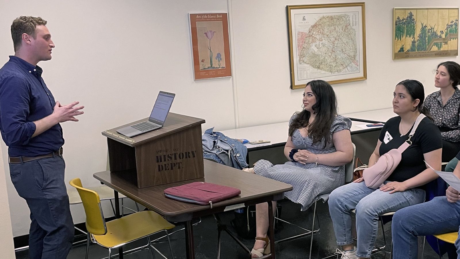 Professor teaching a class while students listen