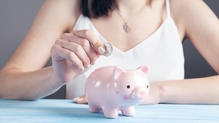 student saving money in piggy bank