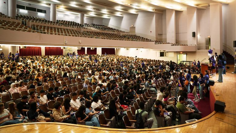 Hunter college freshman students in the auditorium for orientation event.