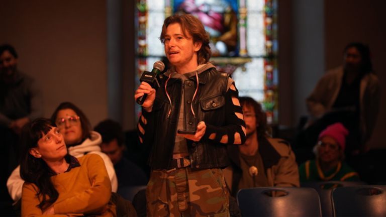 Theatre artist Gagarin speaks at the January “We the People” Assembly while other artists listen