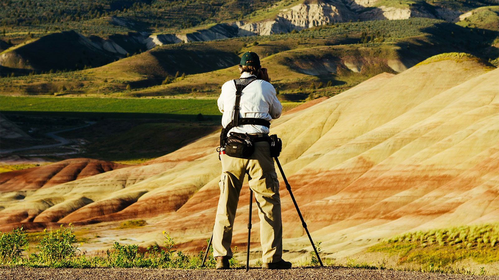 photo of photographer on plains with mountains in background