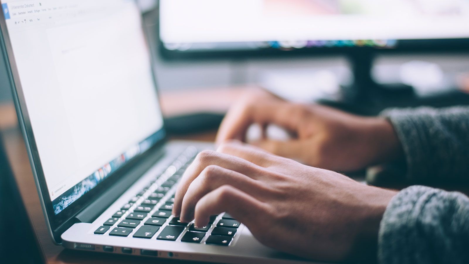 person typing on laptop computer