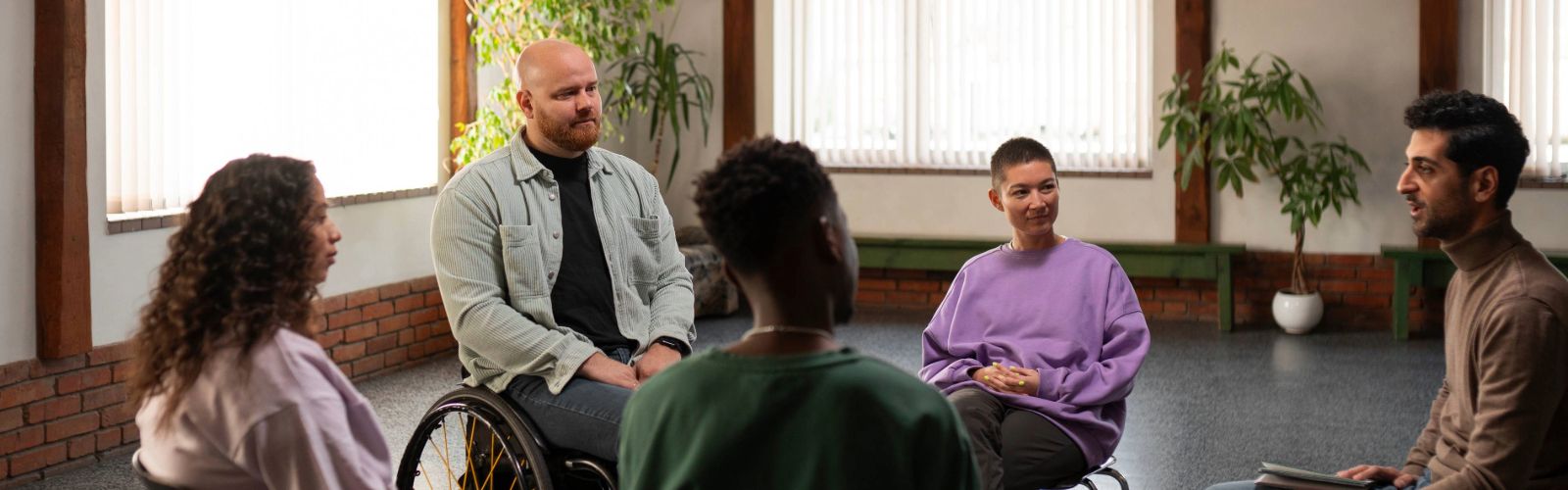 people meeting in therapy support group
