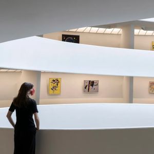 Woman stands in the Guggenheim rotunda.