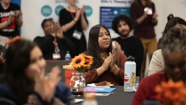 An image of people clapping in the audience.