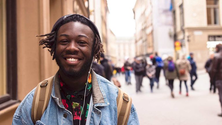 cheerful student on city street