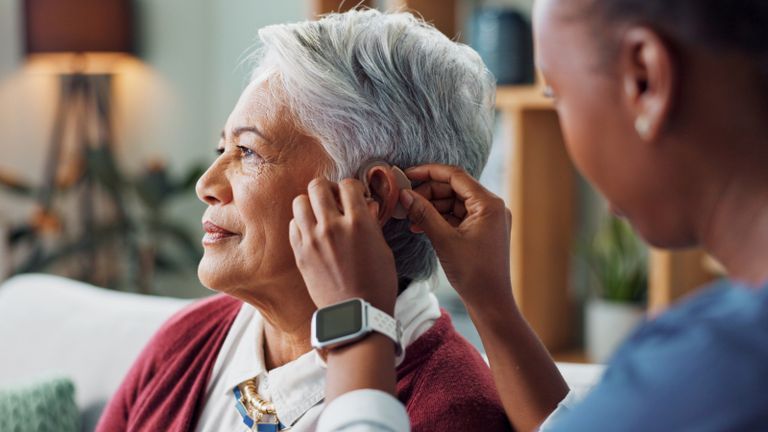 Person being assisted with a hearing aid