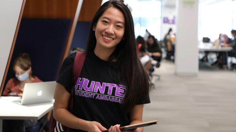 Hunter College Student Ambassador in the Library.