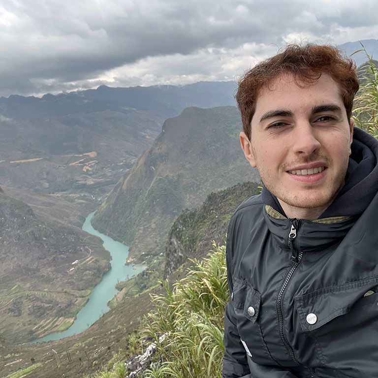 hunter student with mountains and river in background