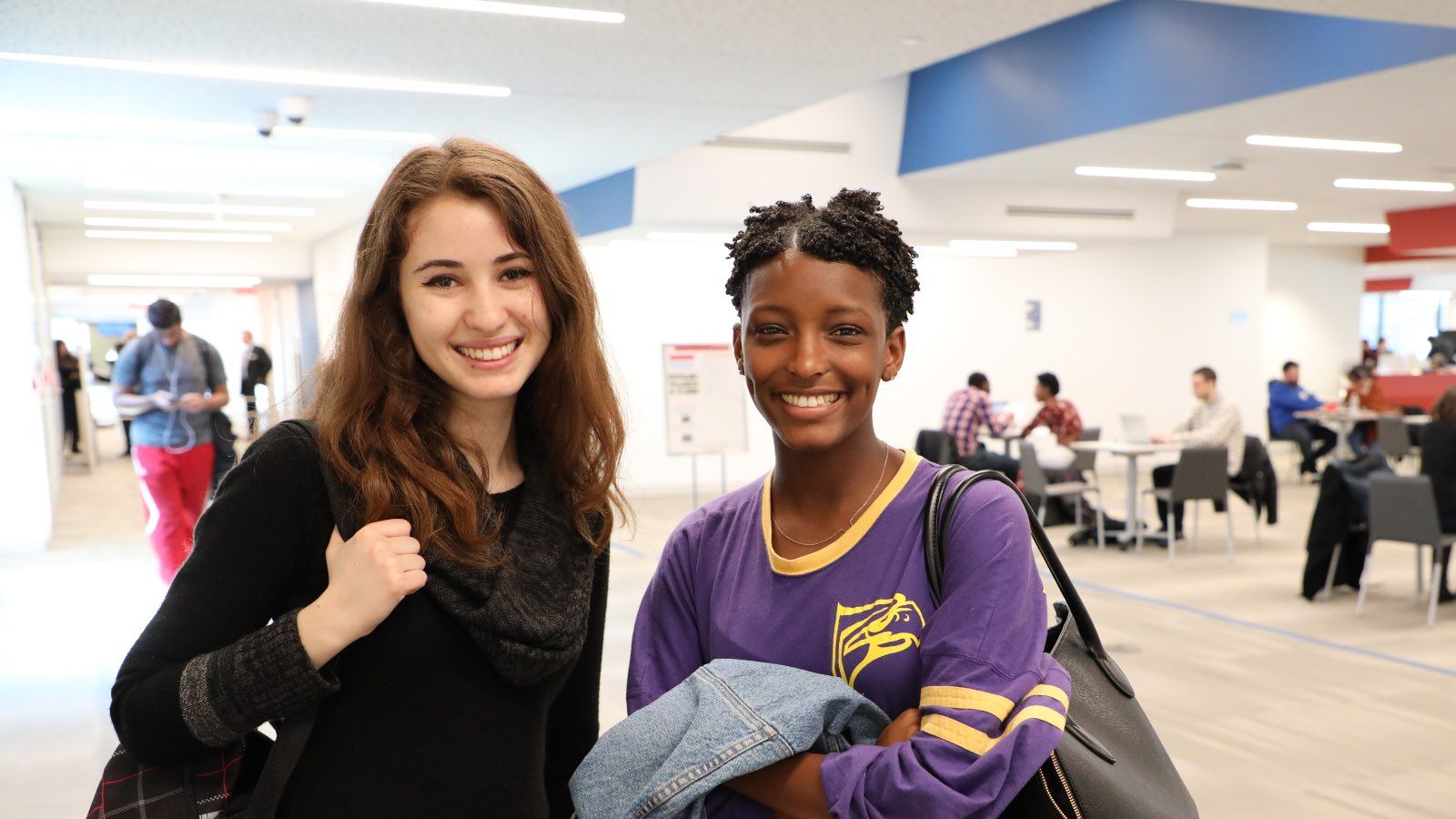 Photo - Two smiling students in the Barbara Lang Student Commons
