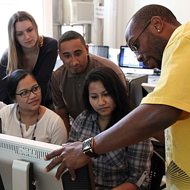 Hunter professor with students at computer