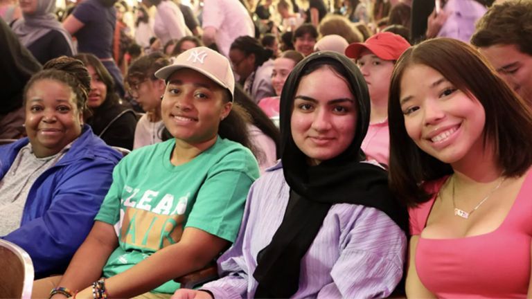 A group of Hunter students posing for a picture and smiling.