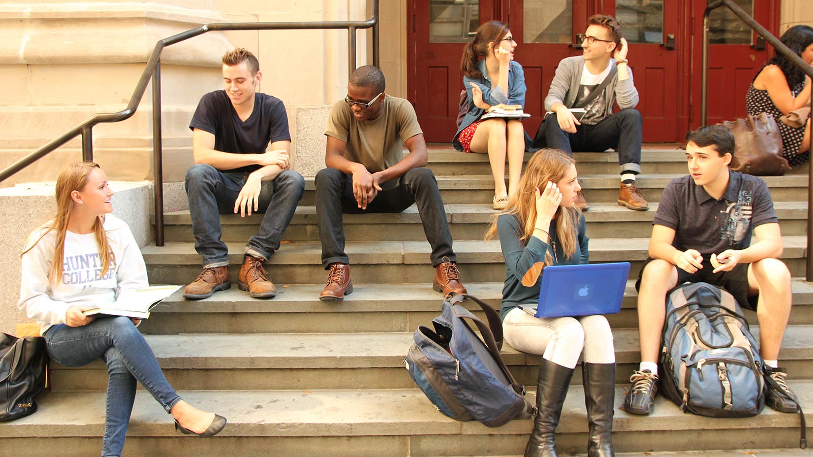 a group of students sitting on steps