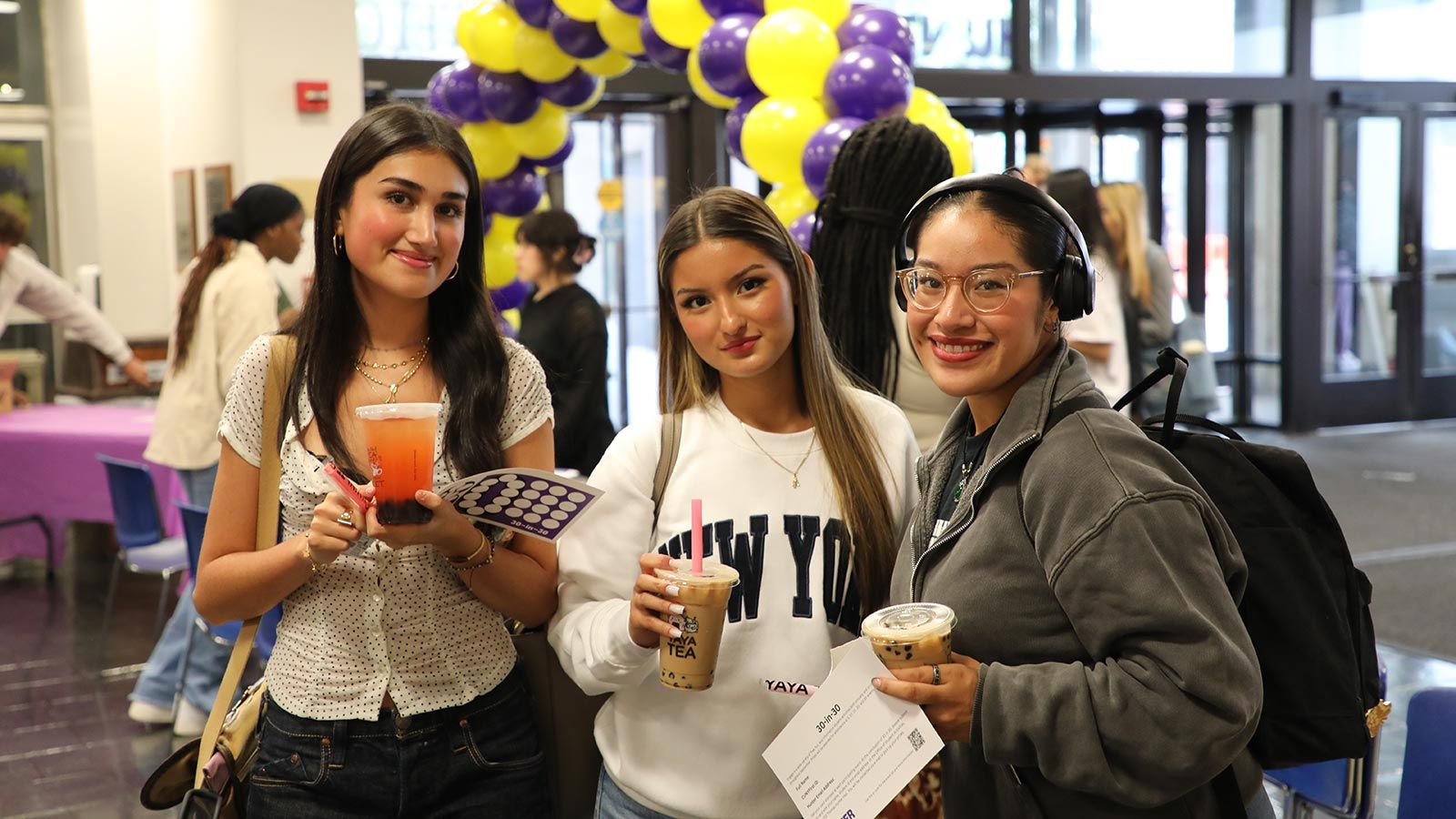 three hunter students enjoying boba tea at the welcome party in the west lobby