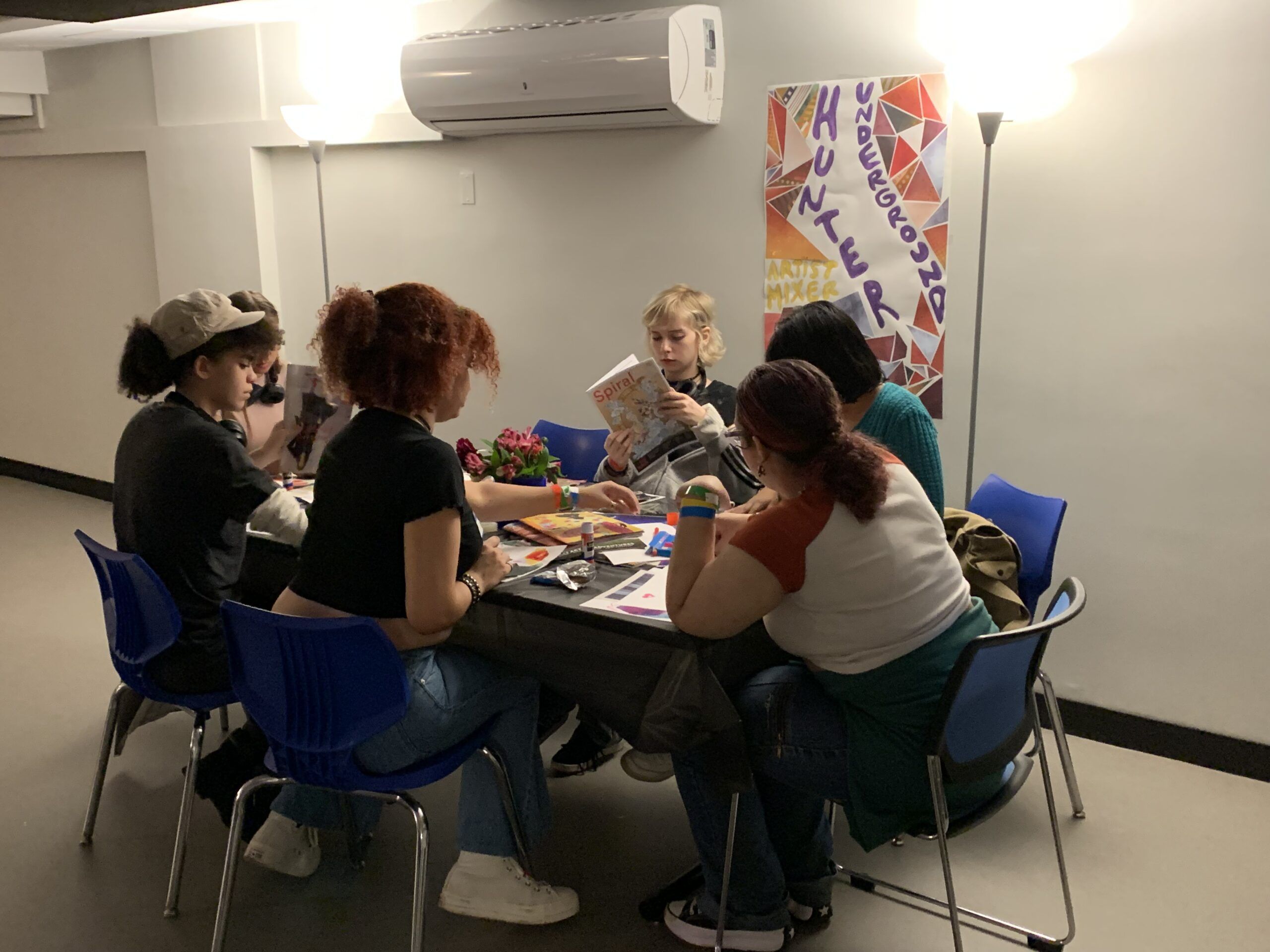 Student sit and talk during Hunter Underground Mixer