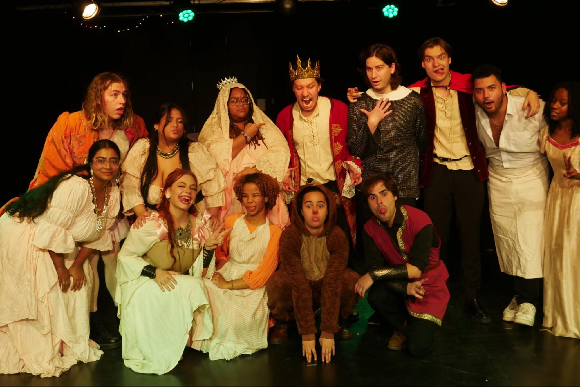 Students pose for cast photo in costumes.