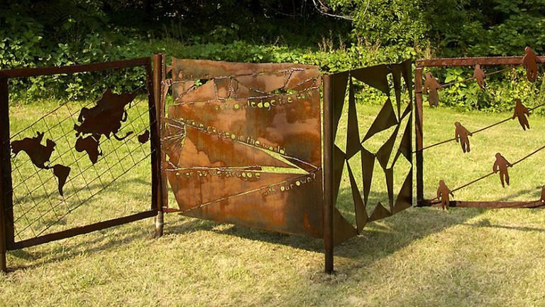 A metal sculpture on green grass.