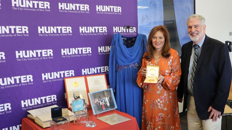 Hunter College President Jennifer J. Raab and Jonathan Elion with the Nobel Prize and other memorabilia.