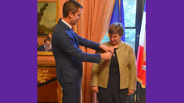 Jessica Neuwirth receiving the insignia of the Knight of the National Order of the Legion of Honor from Jérémie Robert, the Consul General of France in New York.
