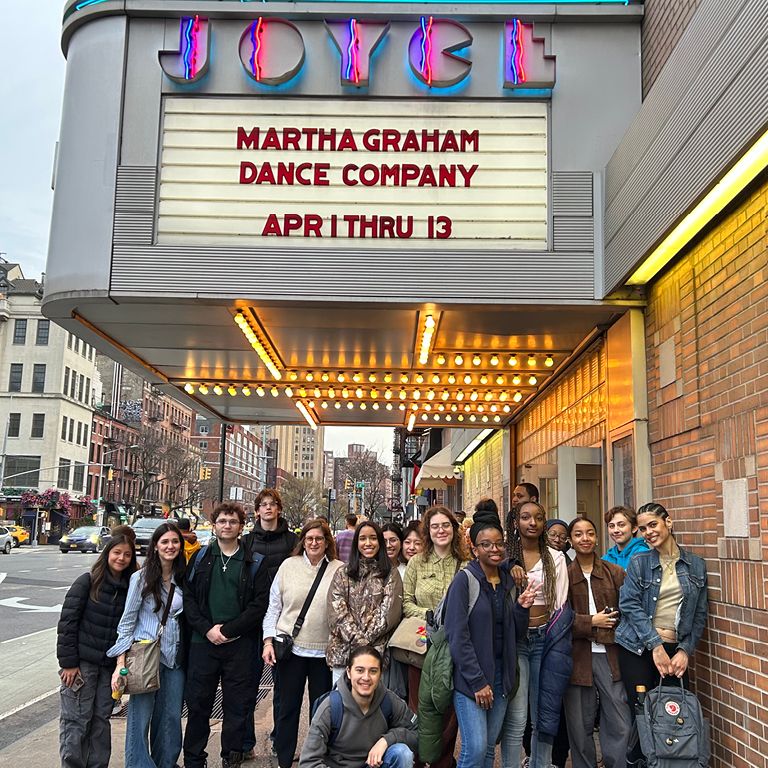 Muse students smile in front of the Joyce Theater.