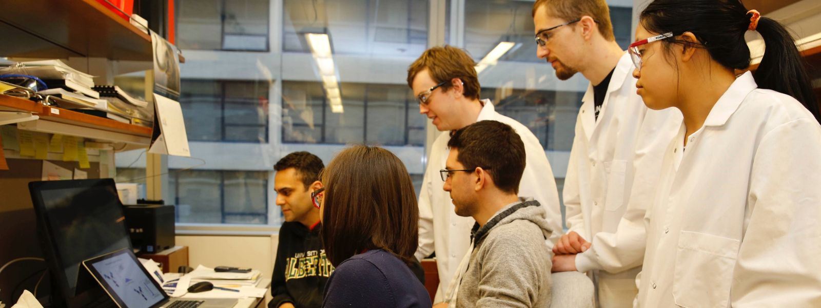 Students in a laboratory looking at a computer.