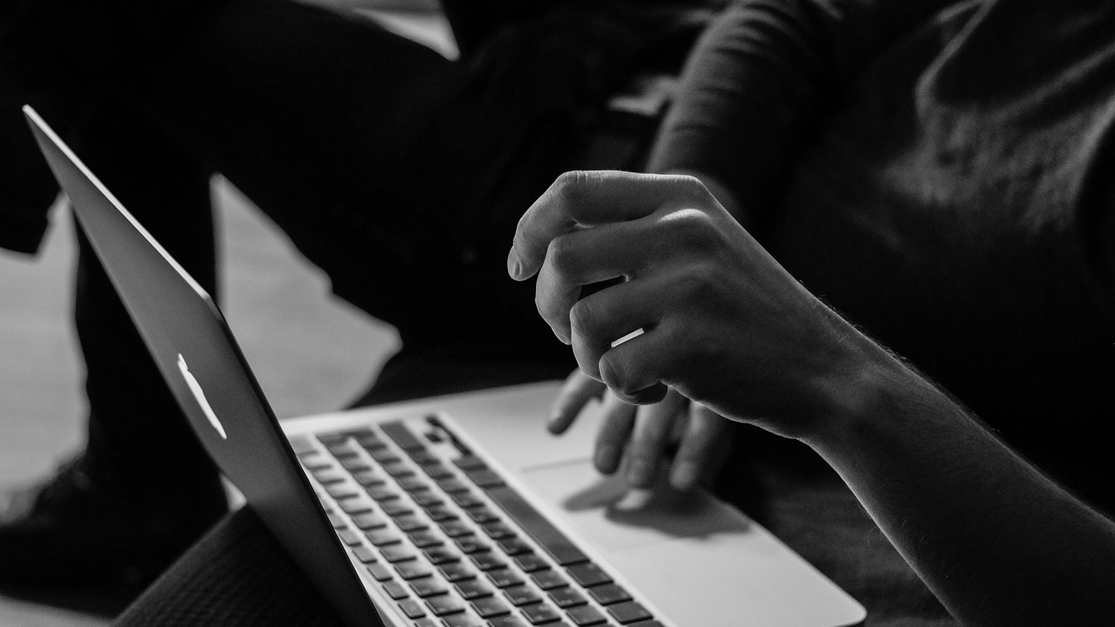 laptop with hands at keyboard