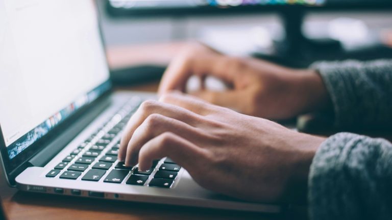 Person typing on laptop