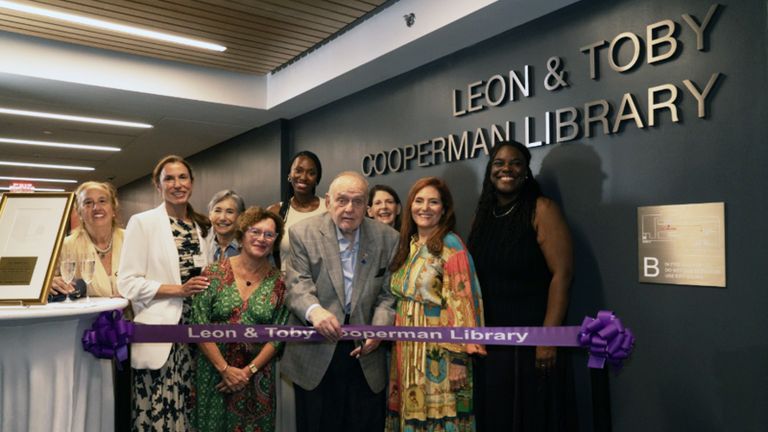 People posing for a photograph in the Leon and Toby Cooperman Library