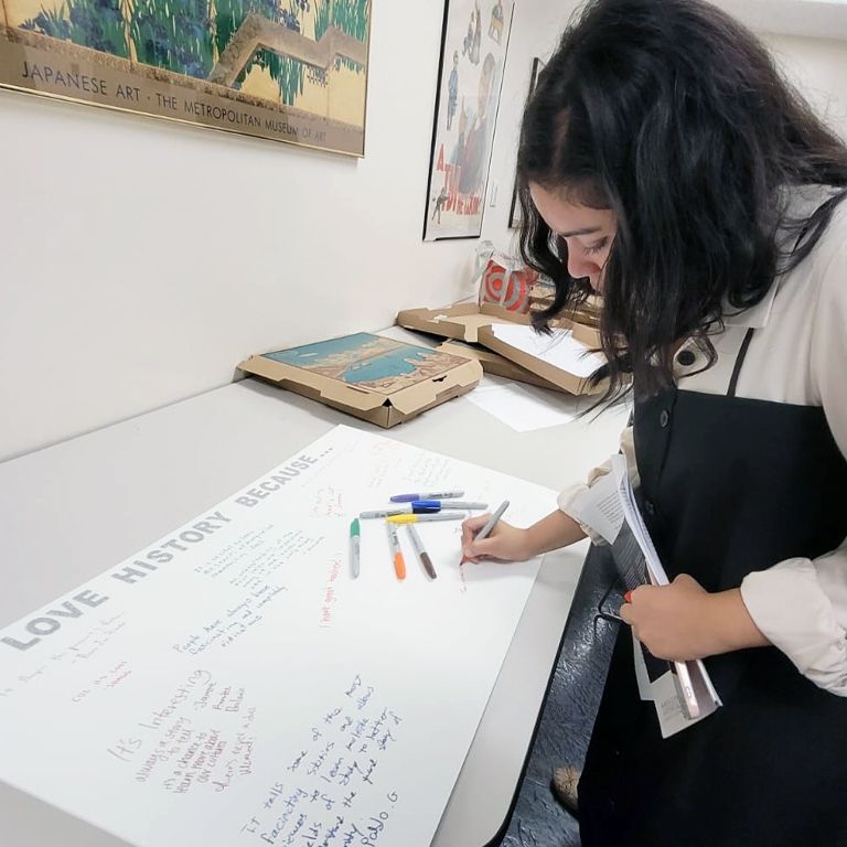 Student signing a poster